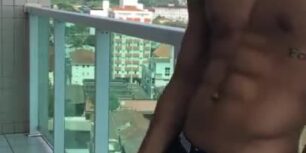 Beautiful guy stroking his cock in the balcony