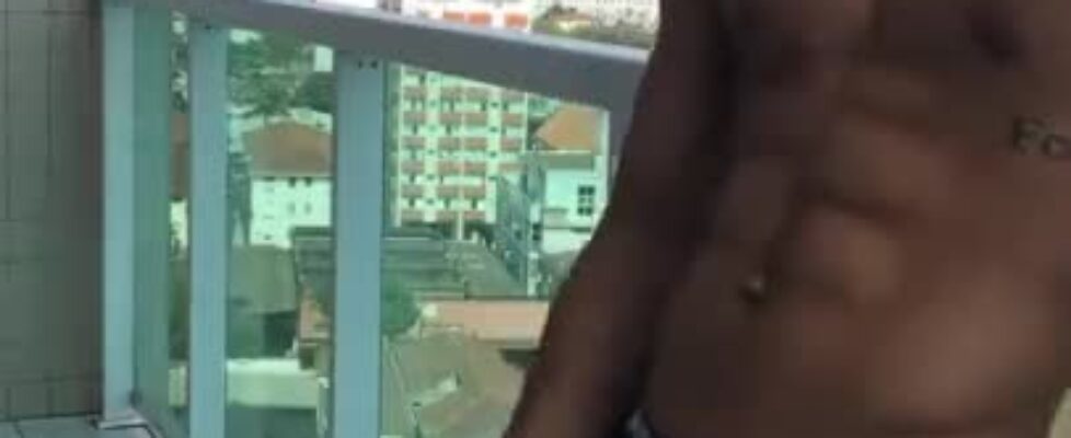 Beautiful guy stroking his cock in the balcony