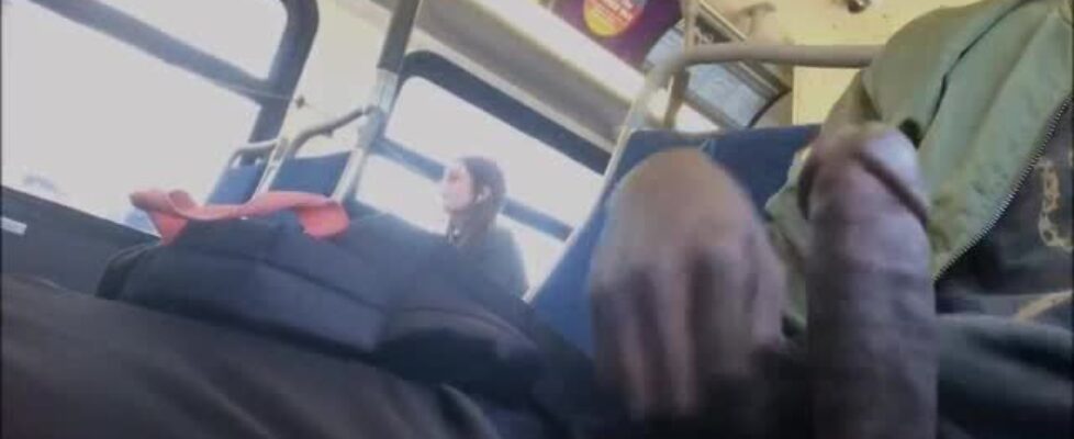 Young black stroking his cock on a bus