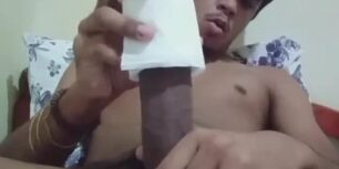 Young Latino uses a roll of paper to masturbate