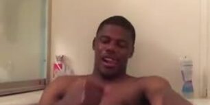 black in the bathtub strokes his huge cock while taking a bath