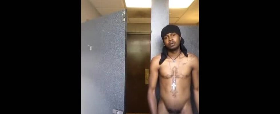 Black thug stroking his cock in a public bathroom and shooting a huge load