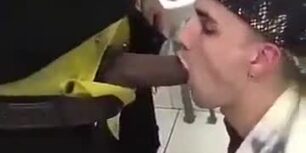 Young white boy sucks stranger black cock in public toilet