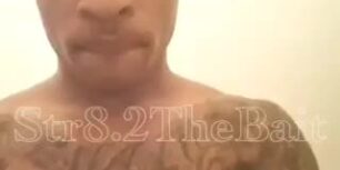 Hot tattooed black dude stroking his cock in the gym bathroom