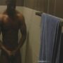 Muscled black guy jerking off while he showers