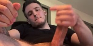 Handsome young dude rubbing his huge curved cock