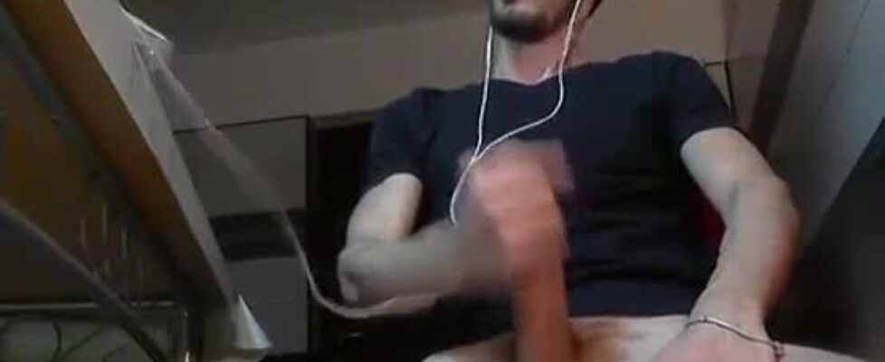 Skinny horny guy rubbing his huge cock while watching porn on his computer