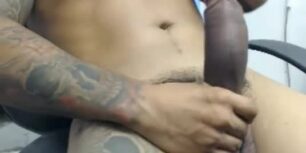 Tattooed latino shows off his huge thick cock