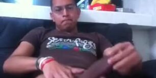 Young peruvian guy gropes his fat cock on the couch