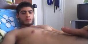 Cute peruvian stroking his cock on the bed