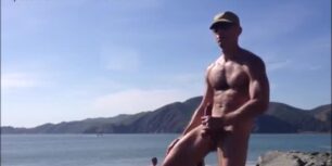 Handsome stud stroking his cock at the beach