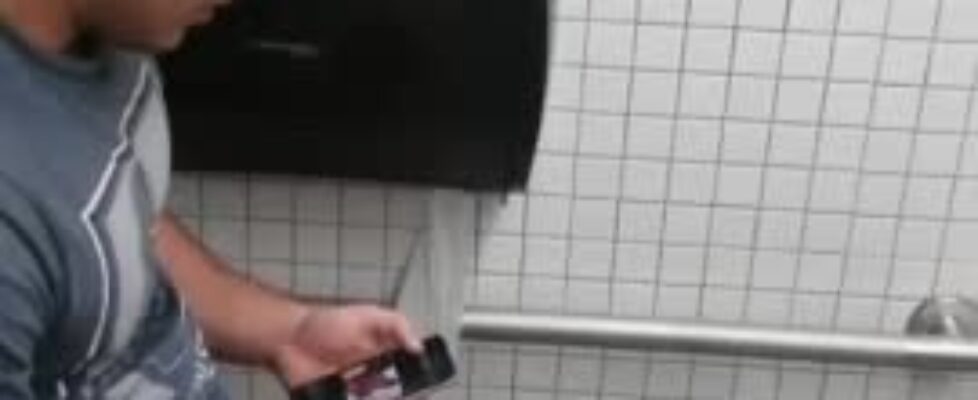 Spying a hot latino stroking his cock in public toilet