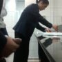 Horny salesman strokes his cock in a public toilet in front of every one