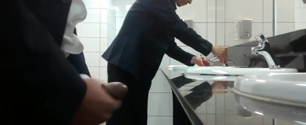 Horny salesman strokes his cock in a public toilet in front of every one