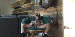 Horny nigga stroking his huge cock on the sofa