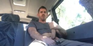 Sexy stud stroking his huge cock in a van