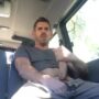 Sexy stud stroking his huge cock in a van