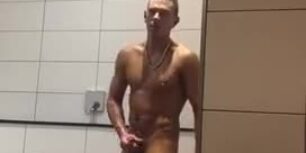 Cute yoing guy wankking his cock in a public shower