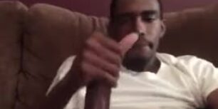 Big black dick strokes out in his living room